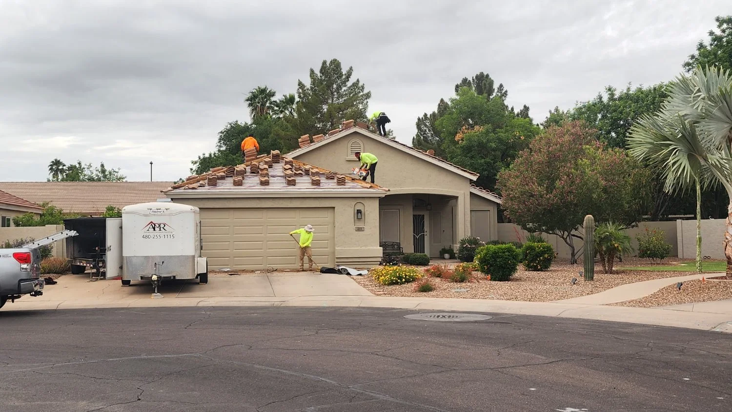Advanced Precision Roofing crew working on a tile roof