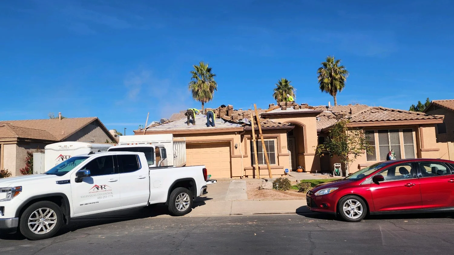 Advanced Precision Roofing truck parked in a residential driveway