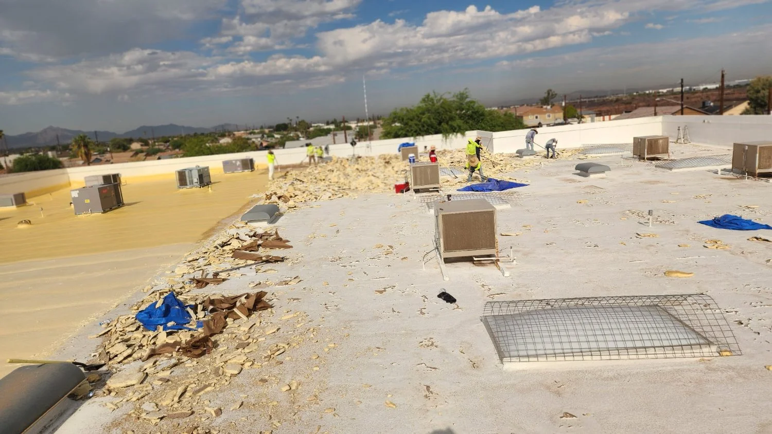 Debris cleared during a commercial flat roof tear-off
