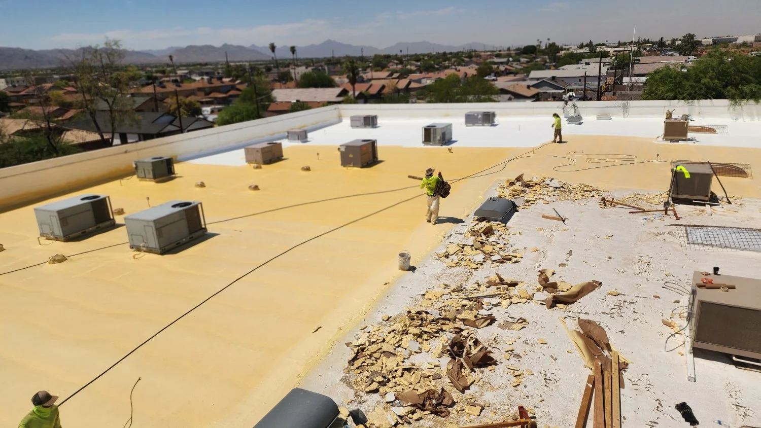 Tear-off in progress on a commercial foam roof