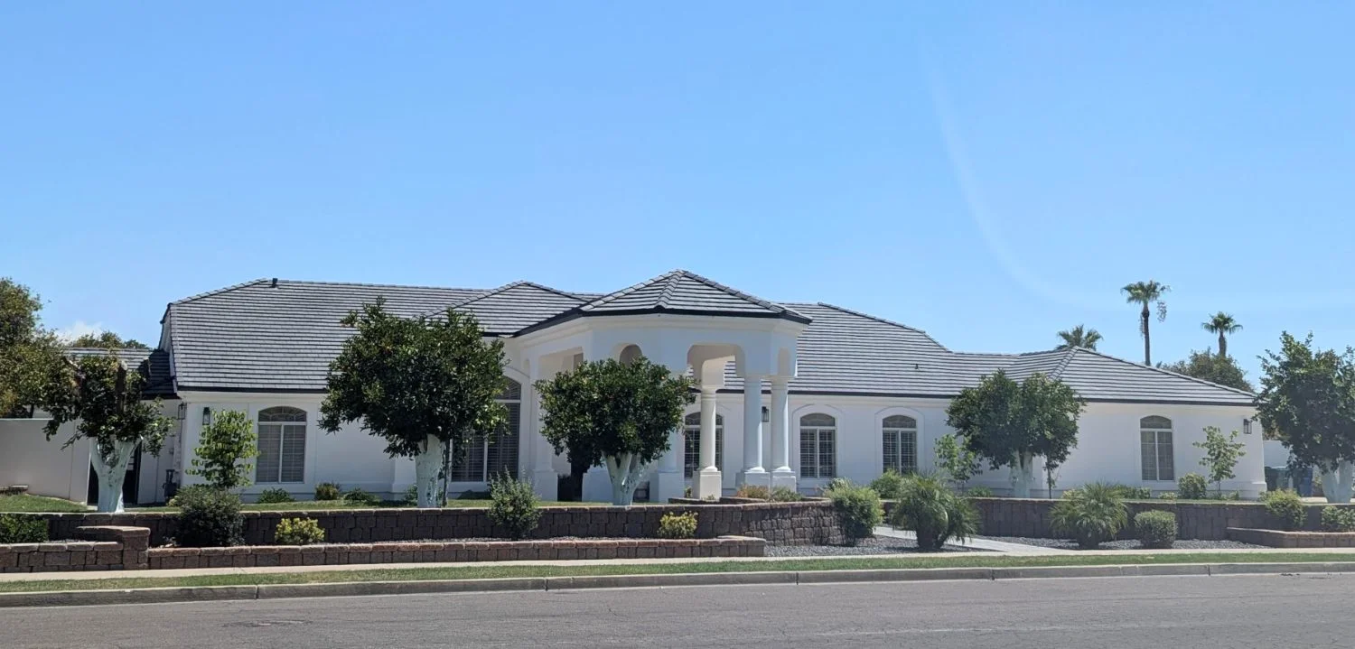Completed tile roof on a white estate home