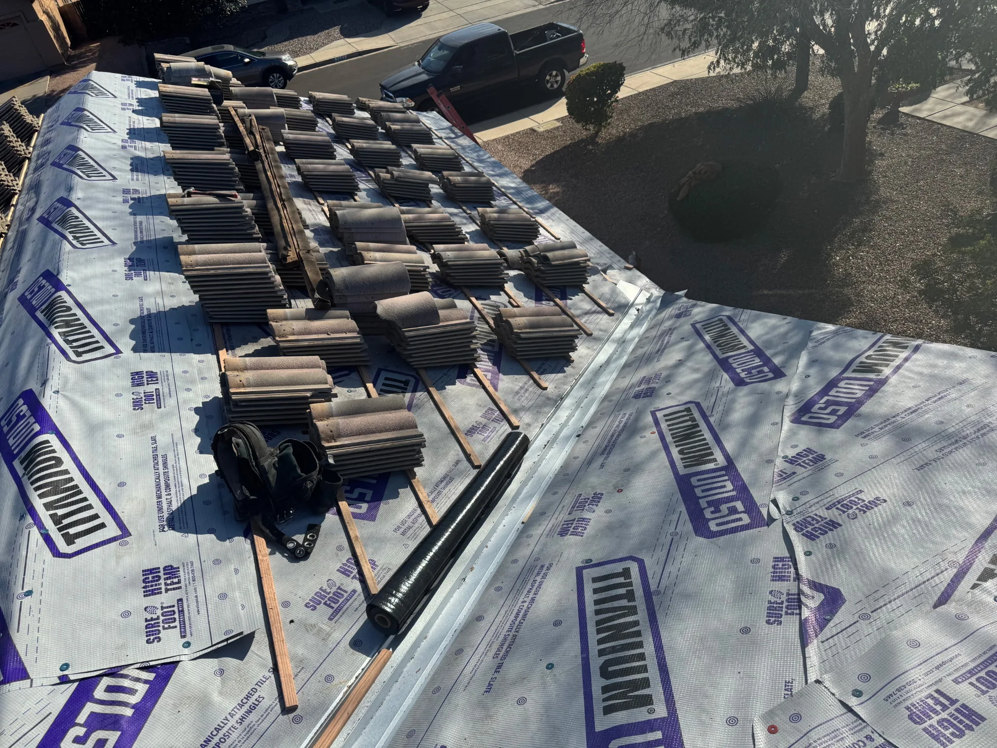 Tile roof mid-project with tile stacked aside and new high-temperature underlayment exposed