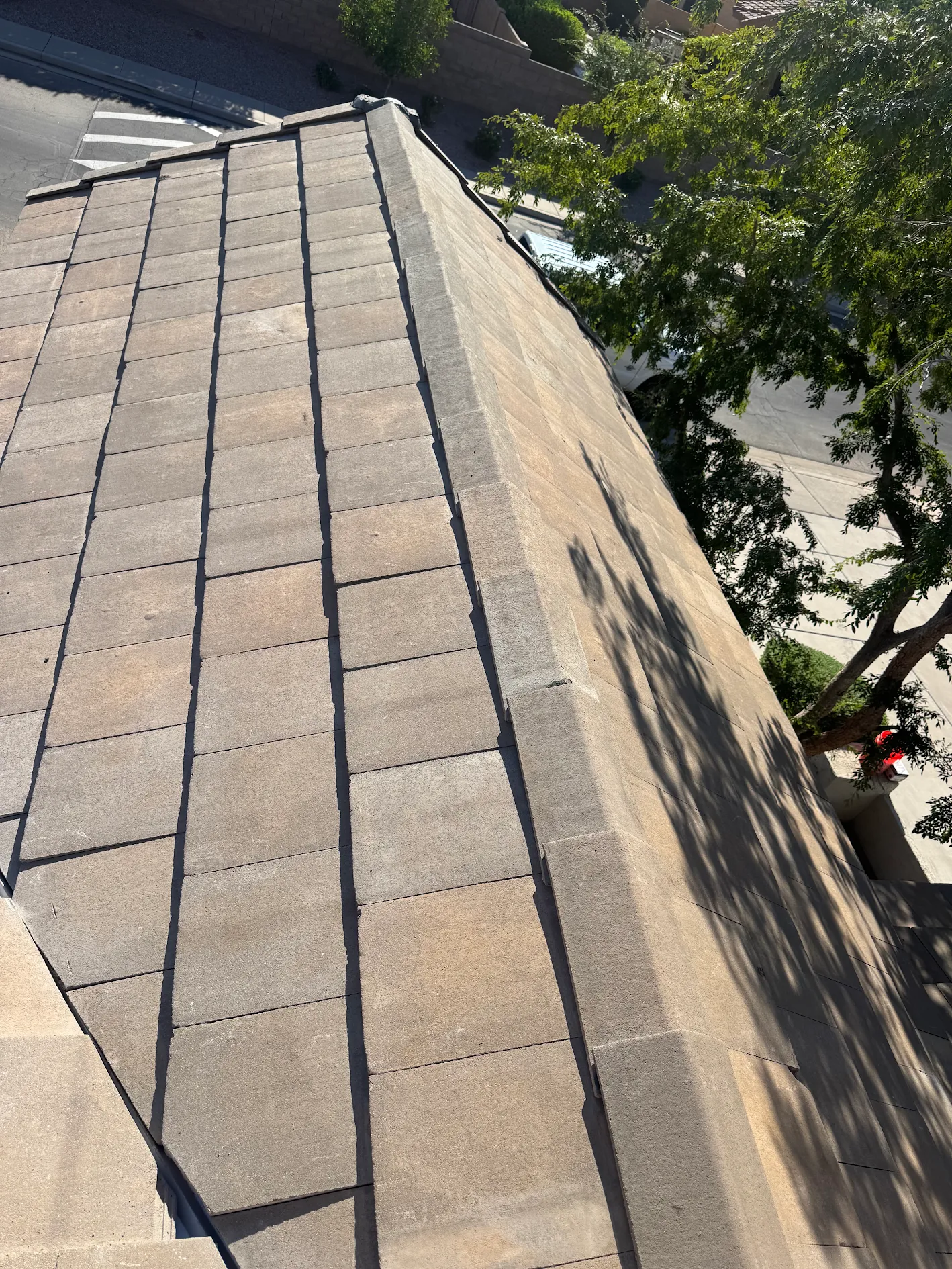 Looking down the hip of a finished flat concrete tile roof