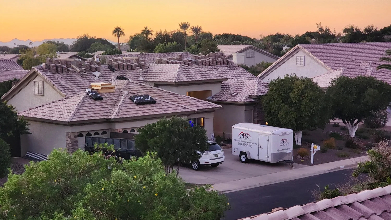 Full-bleed hero photo: finished concrete tile roof in warm Arizona daylight